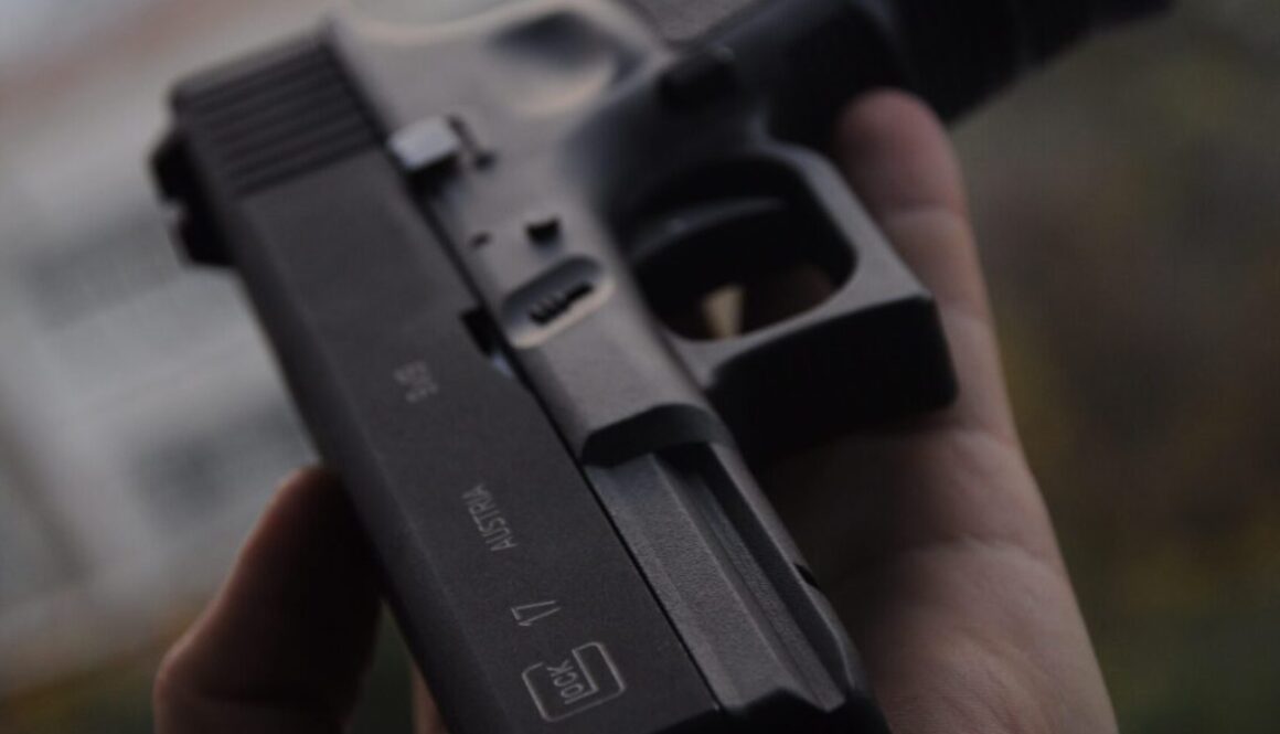 person holding black semi automatic pistol