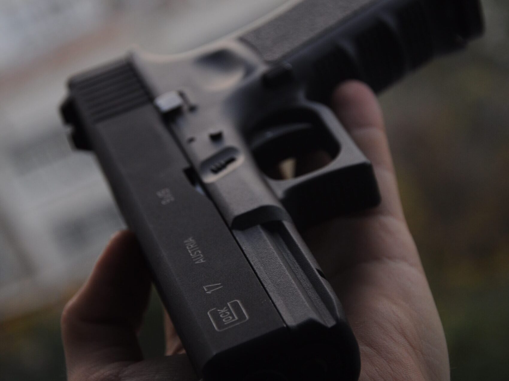 person holding black semi automatic pistol