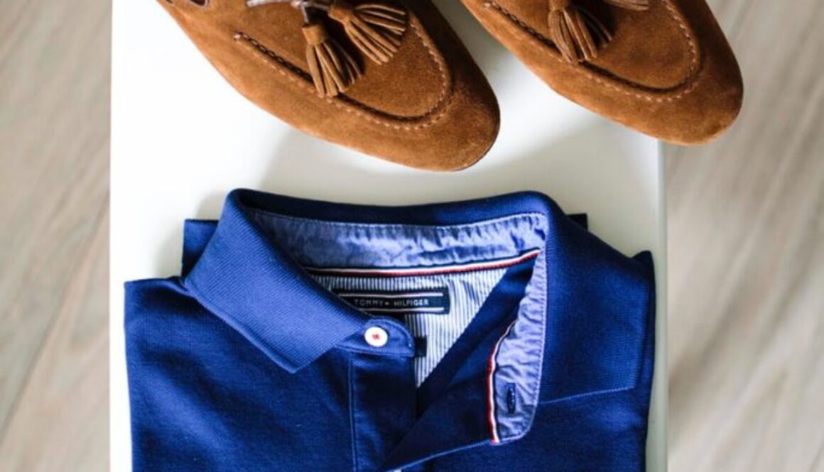 pair of brown loafers and blue polo shirt