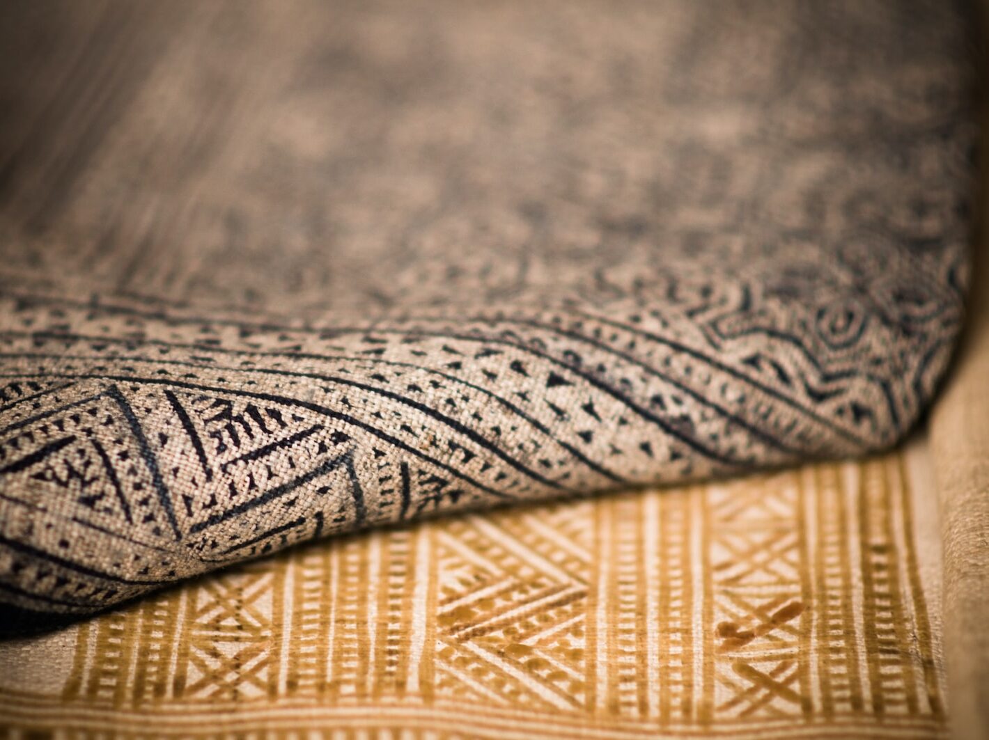 A close up that shows the texture of two different patterned rugs