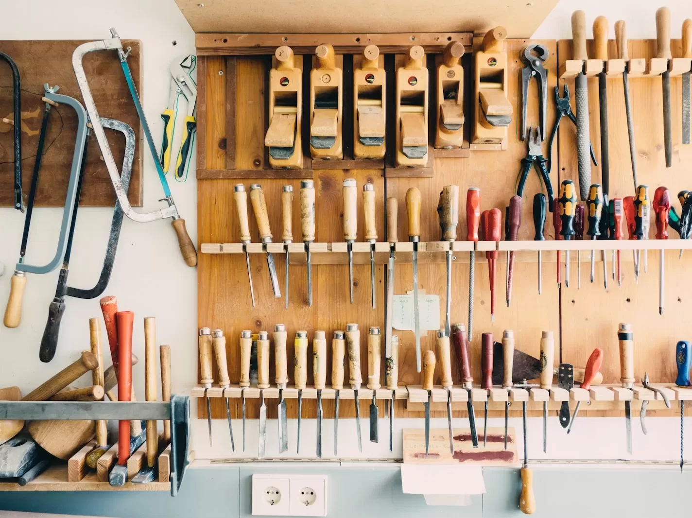 assorted handheld tools in tool rack