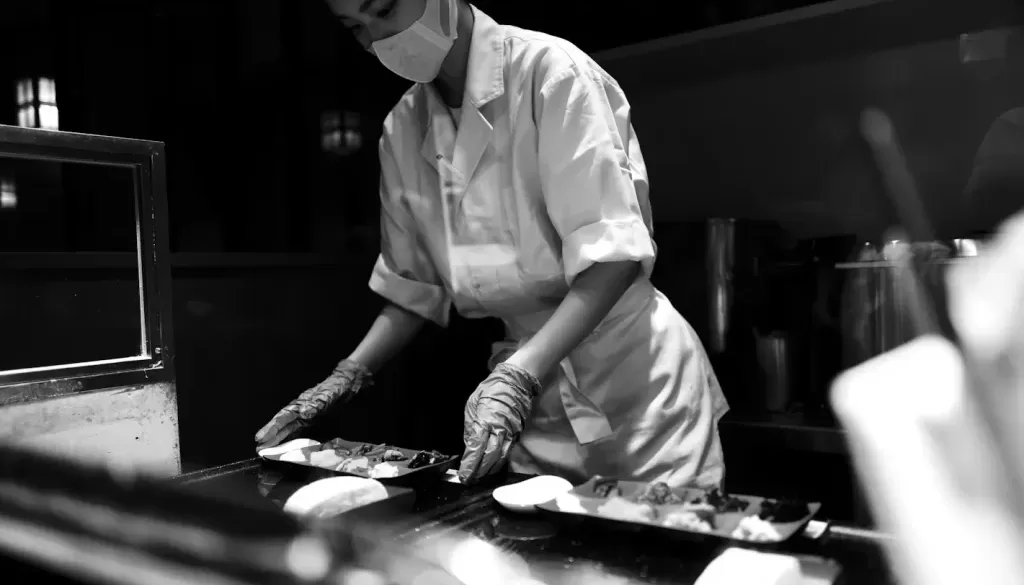 man in white chef uniform holding knife