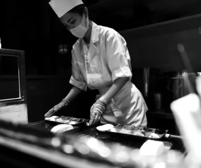 man in white chef uniform holding knife